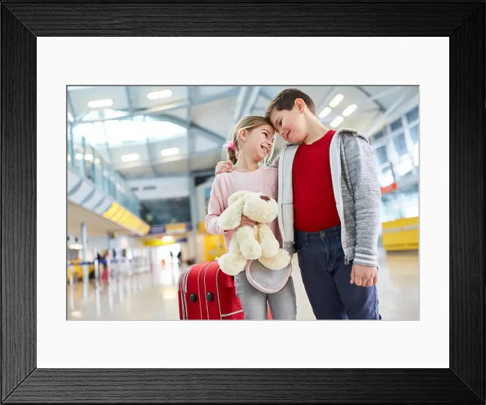 Framed Print : Boy and girl as first love together in the airport terminal before a trip Framed Print : Boy and girl as first love together in the airport terminal before a trip
