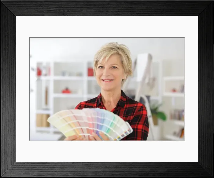Framed Print : mature woman holding a color swatch Framed Print : mature woman holding a color swatch