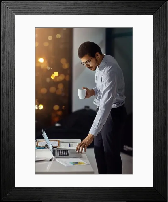 Framed Print : Laptop, night coffee and businessman reading feedback review of financial portfolio Framed Print : Laptop, night coffee and businessman reading feedback review of financial portfolio
