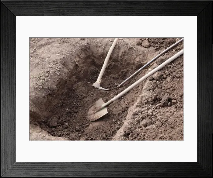 Framed Print : Digging a pit. Pit in the ground. The shovel, pickaxe and crowbar lay in the pit Framed Print : Digging a pit. Pit in the ground. The shovel, pickaxe and crowbar lay in the pit