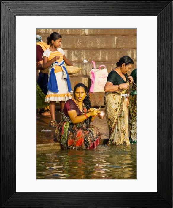 Framed Print : Women come to bathe and pray in the holy waters of the Ganges River in the Hindu city of Varanasi, India Framed Print : Women come to bathe and pray in the holy waters of the Ganges River in the Hindu city of Varanasi, India
