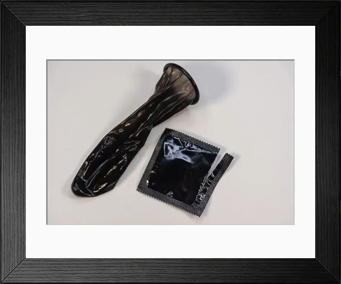Framed Print : Display of colored condom arranged neatly on a platform