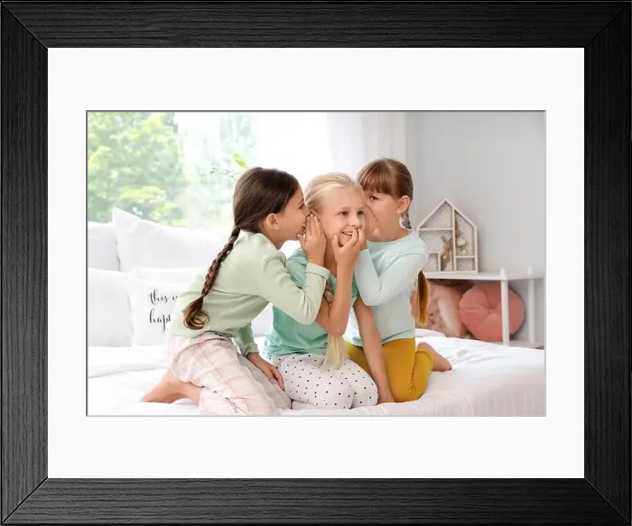 Framed Print : Cute little girls telling secrets in bedroom Framed Print : Cute little girls telling secrets in bedroom