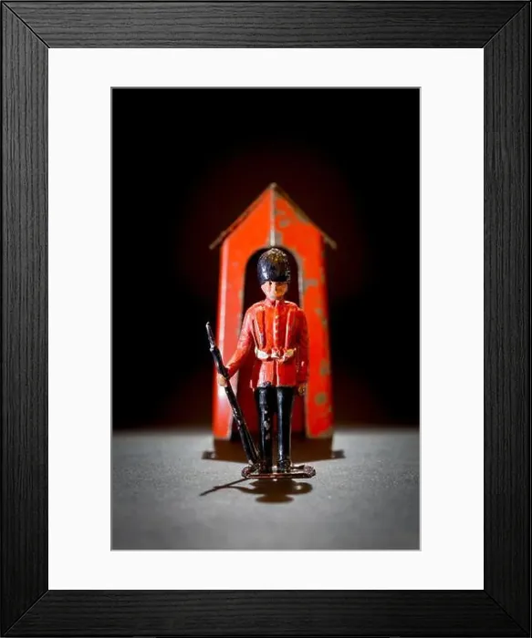 Framed Print : Metal lead toy soldier guardsman with a metal sentry box in play worn condition Framed Print : Metal lead toy soldier guardsman with a metal sentry box in play worn condition