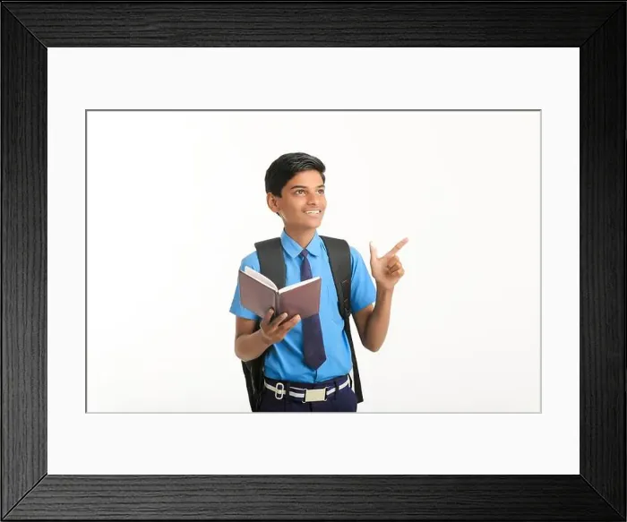 Framed Print : Indian school boy in uniform and reading diary on white background Framed Print : Indian school boy in uniform and reading diary on white background