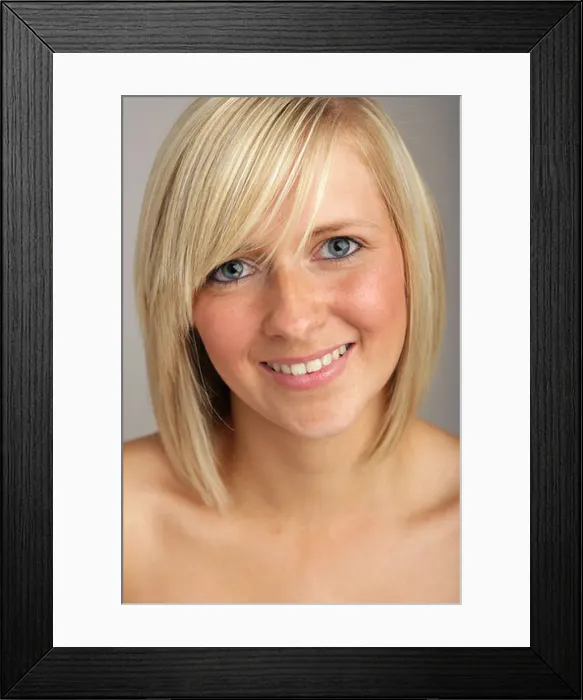 Framed Print : Pretty blonde haired young woman looking at camera and smiling Framed Print : Pretty blonde haired young woman looking at camera and smiling