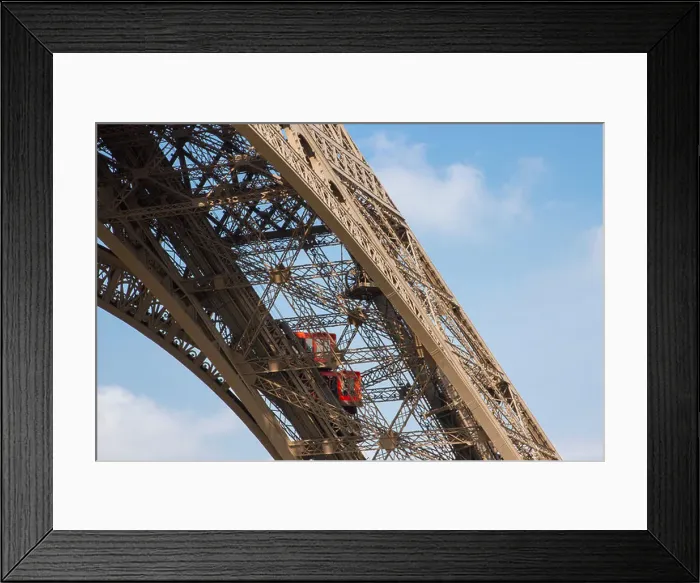 Framed Print : Two bright red elevators climbing up one of Eiffel Tower iron girders bringing tourists to the first floor Framed Print : Two bright red elevators climbing up one of Eiffel Tower iron girders bringing tourists to the first floor