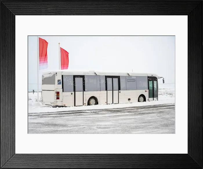 Framed Print : Tourist bus drove through snow capped streets with winter scenery in Iceland Framed Print : Tourist bus drove through snow capped streets with winter scenery in Iceland