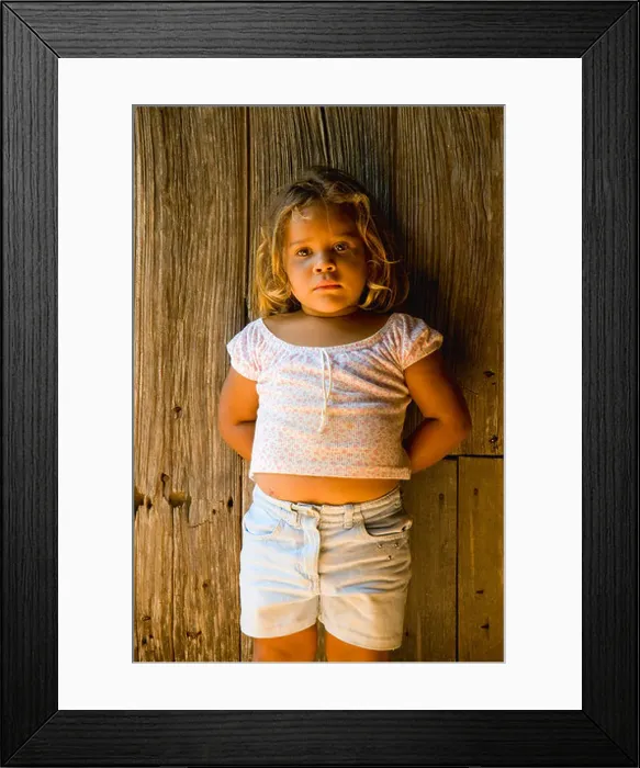 Framed Print : Girl standing at door Framed Print : Girl standing at door