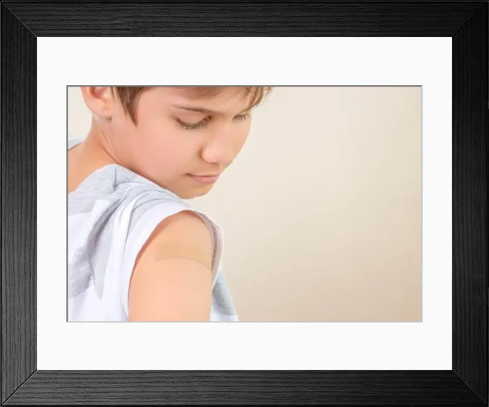 Framed Print : Teenage boy with adhesive bandage plaster on his arm after vaccination Framed Print : Teenage boy with adhesive bandage plaster on his arm after vaccination