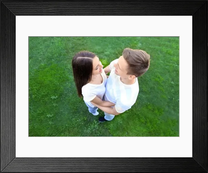 Framed Print : Loving couple on green grass background Framed Print : Loving couple on green grass background