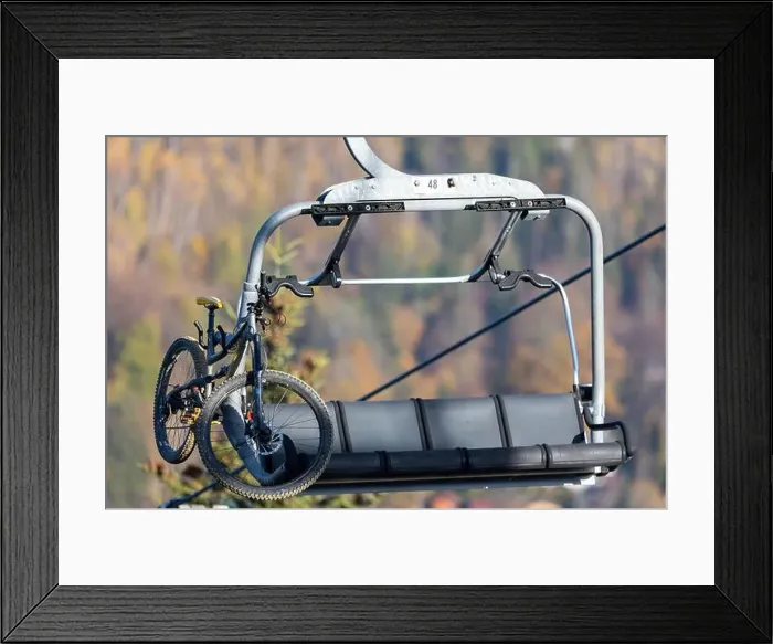 Framed Print : Downhill bicycle on a chairlift. Transportation of downhill bikes to the top of the mountain Framed Print : Downhill bicycle on a chairlift. Transportation of downhill bikes to the top of the mountain