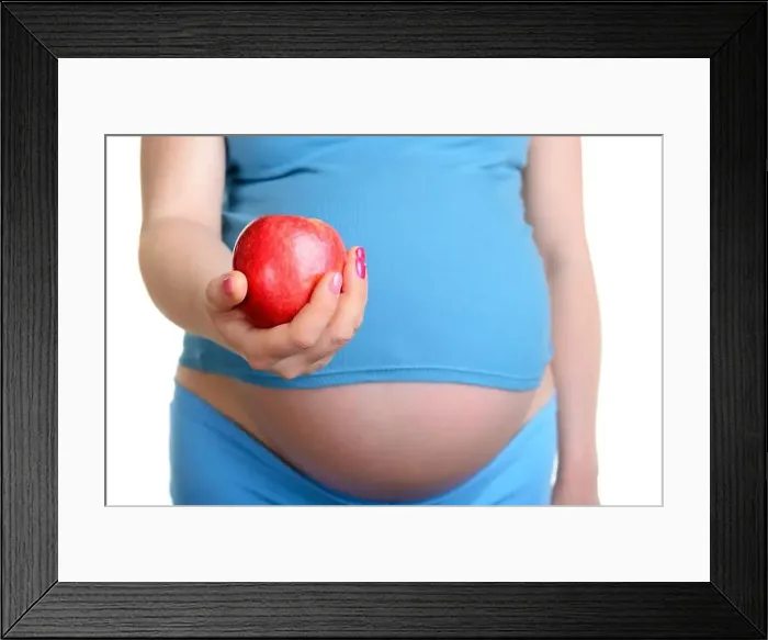 Framed Print : Pregnant woman with red apple isolated on white background Framed Print : Pregnant woman with red apple isolated on white background