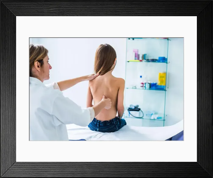 Framed Print : Doctor examining back of 7 year old girl Framed Print : Doctor examining back of 7 year old girl