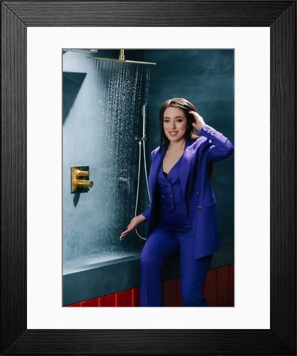 Framed Print : Representative saleswoman in purple suit testing overhead shower, water running Framed Print : Representative saleswoman in purple suit testing overhead shower, water running