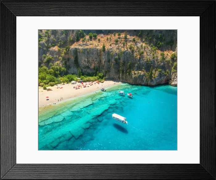 Framed Print : Aerial view of sandy beach, blue sea, boats, rock, umbrellas Framed Print : Aerial view of sandy beach, blue sea, boats, rock, umbrellas