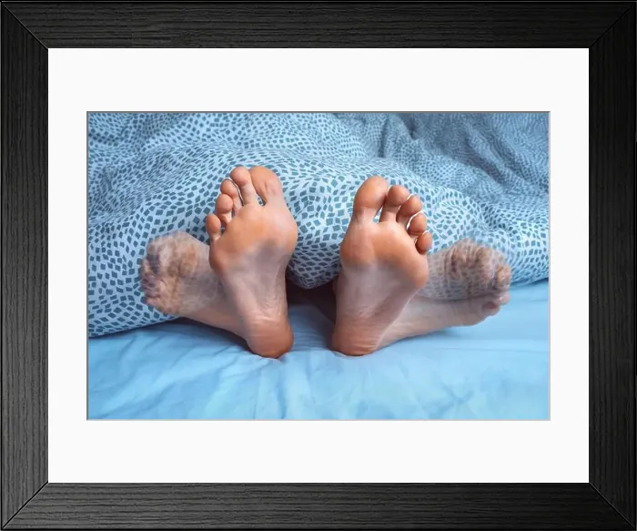 Framed Print : Woman suffering from foot cramps Framed Print : Woman suffering from foot cramps