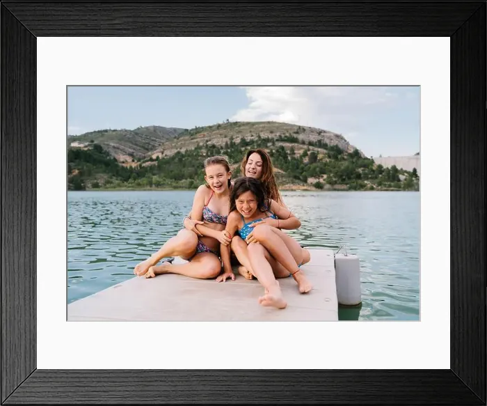 Framed Print : Adult Woman in swimwear tickling cheerful children while sitting relaxing on pier embracing each other during summer Framed Print : Adult Woman in swimwear tickling cheerful children while sitting relaxing on pier embracing each other during summer