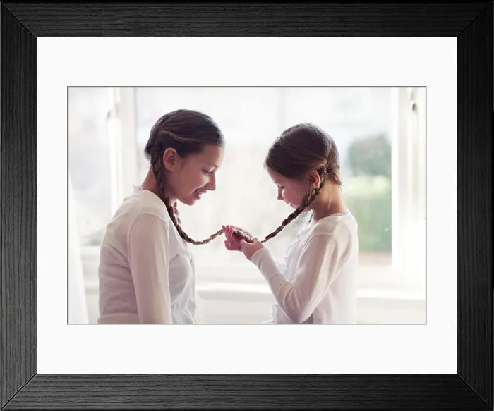 Framed Print : Two girls with their plaits tied together Framed Print : Two girls with their plaits tied together