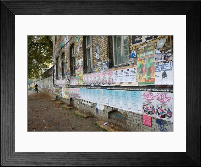 Framed Print : Man putting up posters Framed Print : Man putting up posters