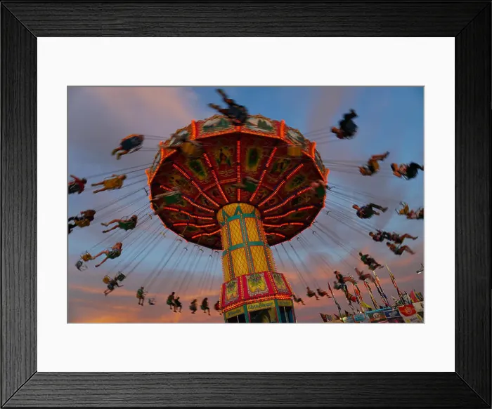 Framed Print : Kids enjoy a giant swing ride at a local carnival Framed Print : Kids enjoy a giant swing ride at a local carnival