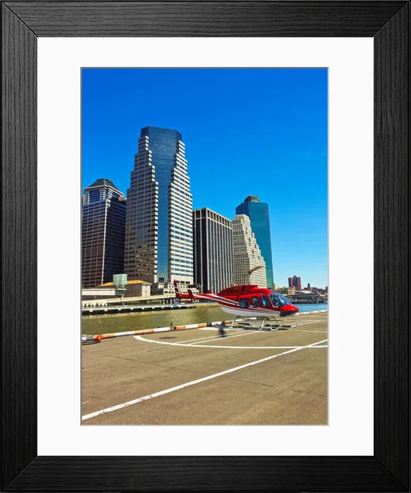 Framed Print : Helicopter landing on helipad in Lower Manhattan New York, USA, on East River. Pier 6. Skyscrapers on the background Framed Print : Helicopter landing on helipad in Lower Manhattan New York, USA, on East River. Pier 6. Skyscrapers on the background