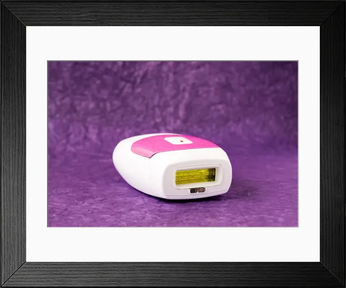 Framed Print : IPL hair removal epilator on a purple background Framed Print : IPL hair removal epilator on a purple background