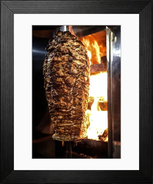 Framed Print : Charcoal shawarma meat. Closeup of chicken meat collected on a vertical skewer and grilled on charcoal Framed Print : Charcoal shawarma meat. Closeup of chicken meat collected on a vertical skewer and grilled on charcoal
