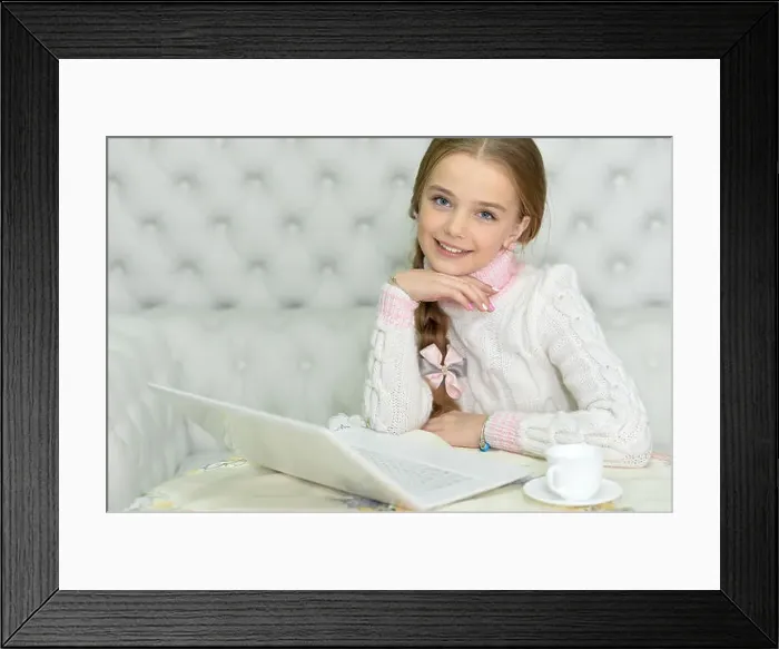 Framed Print : Preteen girl with laptop