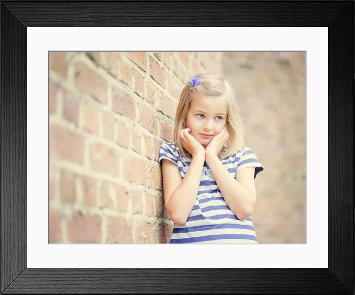Framed Print : Girl, 10 years, leans against a wall, shy look, Portrait, Germany Framed Print : Girl, 10 years, leans against a wall, shy look, Portrait, Germany