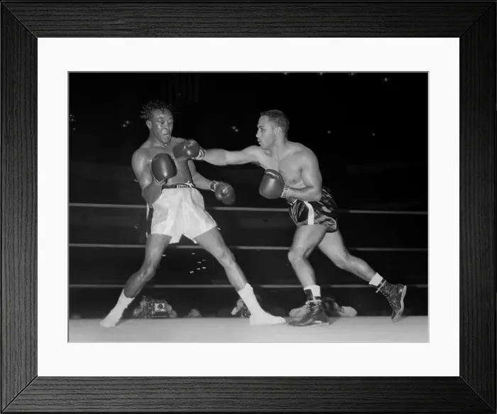 Framed Print : Kid Gavilan takes a punch from Walter Byars during a boxing match in Chicago in 1957 Framed Print : Kid Gavilan takes a punch from Walter Byars during a boxing match in Chicago in 1957