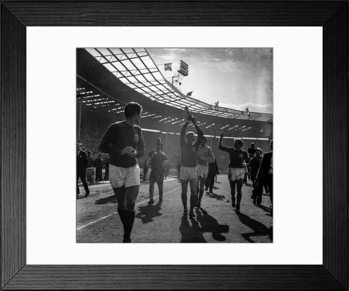 Framed Print : Bobby Moore lifts the Jules Rimet trophy aloft during a lap of honour in Wembley Stadium as the England football team Framed Print : Bobby Moore lifts the Jules Rimet trophy aloft during a lap of honour in Wembley Stadium as the England football team