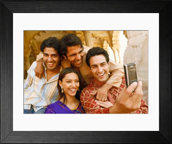 Framed Print : Close-up of three young men and a young woman looking at a mobile phone and smiling, Agra, Uttar Pradesh, India Framed Print : Close-up of three young men and a young woman looking at a mobile phone and smiling, Agra, Uttar Pradesh, India