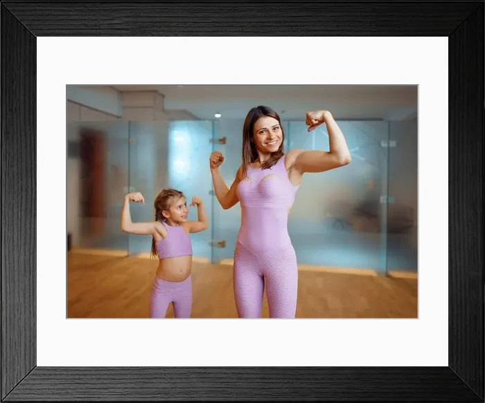 Framed Print : Mother and daughter shows the muscles in gym Framed Print : Mother and daughter shows the muscles in gym