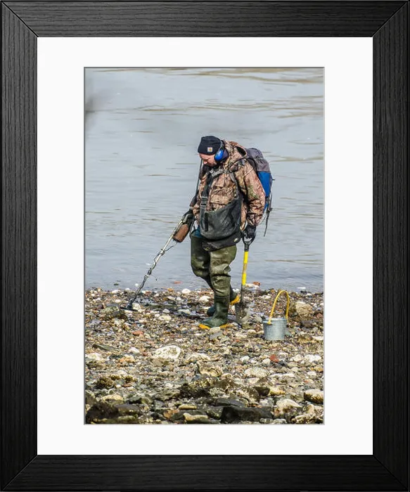 Framed Print : Licensed Mudlark using a metal detector to find valuable or historical items along the Thames riverbank at Battersea Framed Print : Licensed Mudlark using a metal detector to find valuable or historical items along the Thames riverbank at Battersea