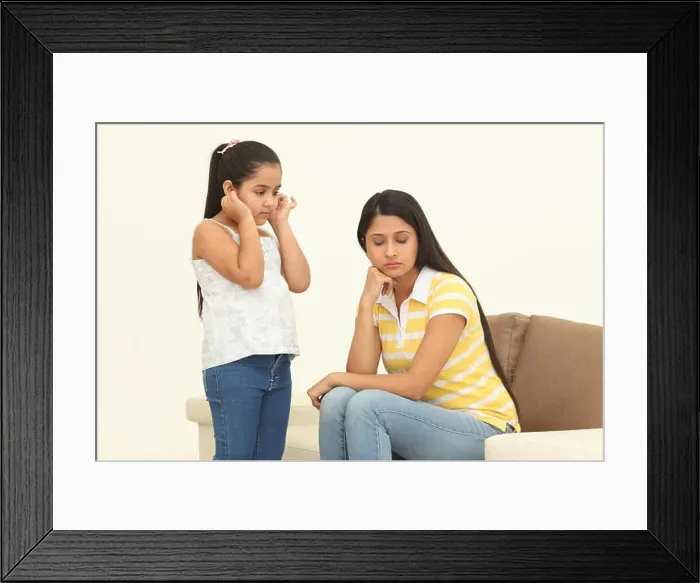 Framed Print : Girl saying sorry to her mother her pulling ears Framed Print : Girl saying sorry to her mother her pulling ears