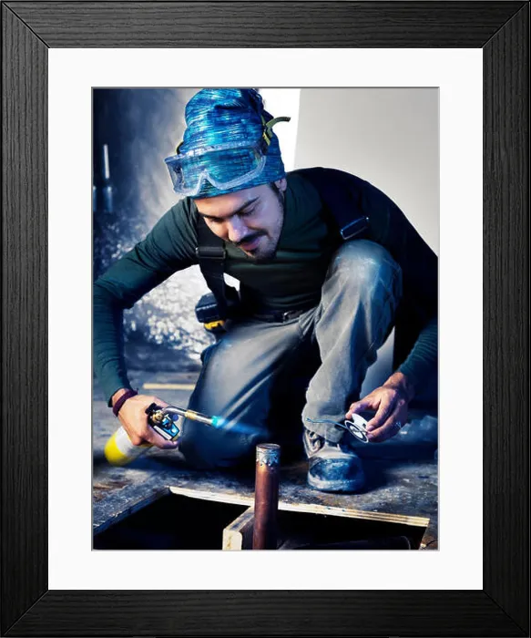 Framed Print : Portrait of man contractor worker with a blow torch capping a pipe doing plumbing Framed Print : Portrait of man contractor worker with a blow torch capping a pipe doing plumbing