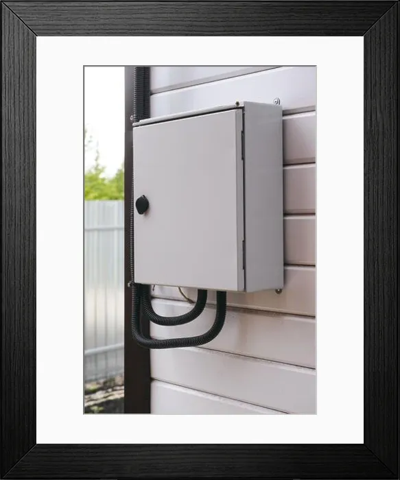 Framed Print : An electrical panel with an electric wires in it on a wall outside the house Framed Print : An electrical panel with an electric wires in it on a wall outside the house