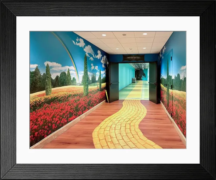 Framed Print : Hallway with yellow brick road, rainbow, and flower scene at Epic Systems on August 4, 2023 in Verona, Wisconsin, USA Framed Print : Hallway with yellow brick road, rainbow, and flower scene at Epic Systems on August 4, 2023 in Verona, Wisconsin, USA