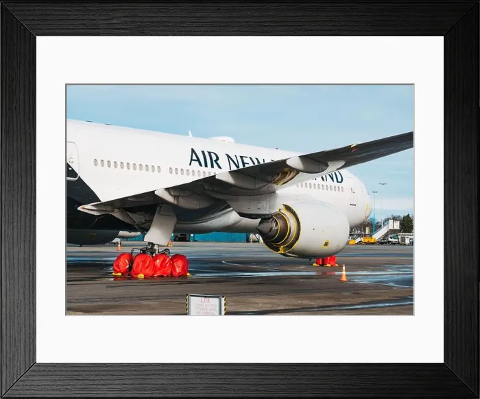 Framed Print : A Boeing 777 in storage with wheel and engine covers in Christchurch Airport during the coronavirus pandemic Framed Print : A Boeing 777 in storage with wheel and engine covers in Christchurch Airport during the coronavirus pandemic