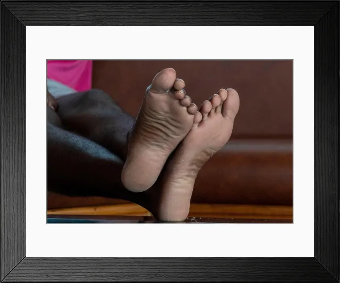 Framed Print : black man crossed feet detail while relaxing Framed Print : black man crossed feet detail while relaxing