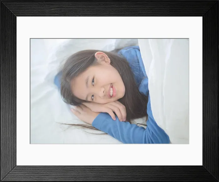 Framed Print : Happy Asian girl lying on the bed with sun light on lazy day
