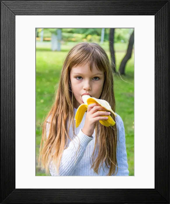 Framed Print : Photo of girl are eating banana in summer Framed Print : Photo of girl are eating banana in summer