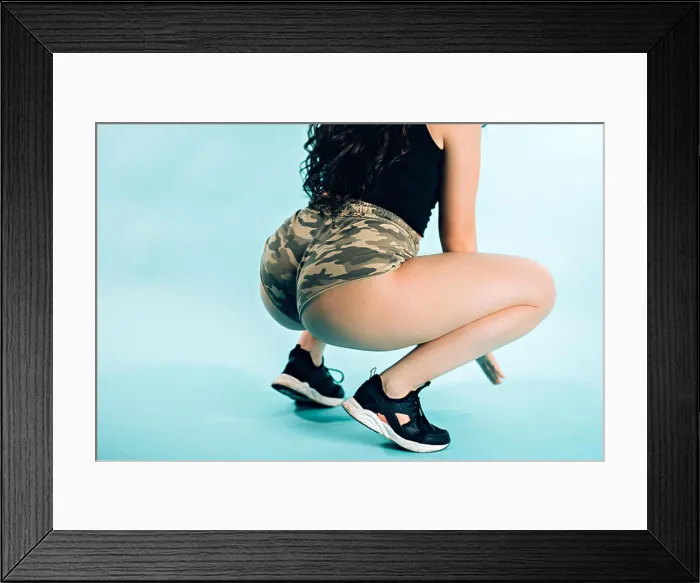 Framed Print : Closeup of woman dancing twerk booty on blue background Framed Print : Closeup of woman dancing twerk booty on blue background