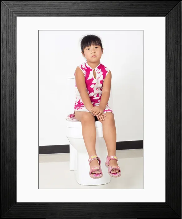 Framed Print : The little girl sitting on the toilet Framed Print : The little girl sitting on the toilet