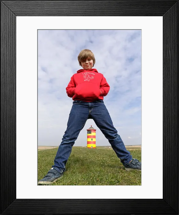 Framed Print : young boy standing straddle-legged in front of Pilsum Lighthouse, East Friesland, Lower Saxony, Germany Framed Print : young boy standing straddle-legged in front of Pilsum Lighthouse, East Friesland, Lower Saxony, Germany
