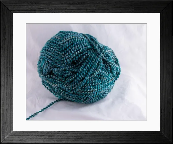 Framed Print : Multi Blue tones of spiral twisted yarn ball with strand leading to left Framed Print : Multi Blue tones of spiral twisted yarn ball with strand leading to left