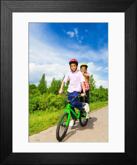 Framed Print : Two happy boys riding same bike both standing Framed Print : Two happy boys riding same bike both standing