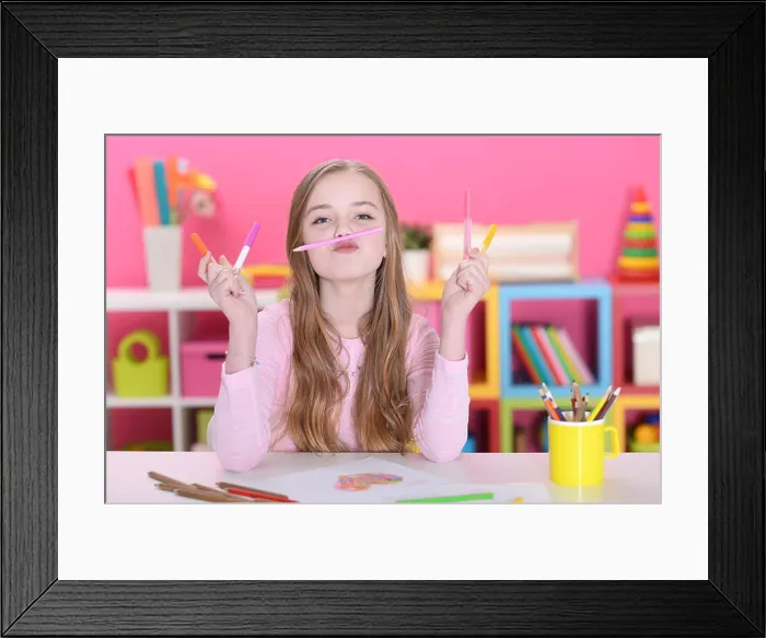 Framed Print : Portrait of cute happy girl drawing with pencils at home Framed Print : Portrait of cute happy girl drawing with pencils at home