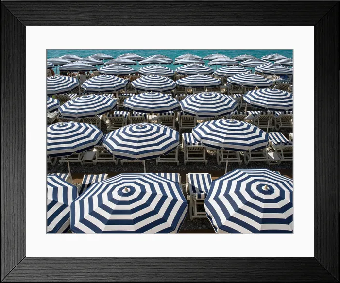 Framed Print : Blue and white beach umbrellas by the sea on the French Riviera Framed Print : Blue and white beach umbrellas by the sea on the French Riviera